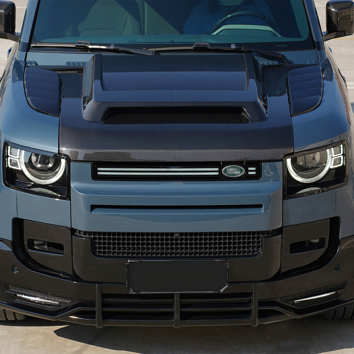 PLOMOR Defender 90/110 carbon fiber engine hood installed aerodynamic view