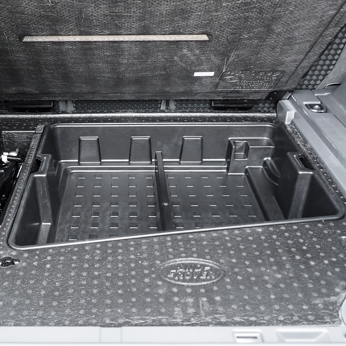 PLOMOR custom-fit rear cargo box mounted in Defender L663