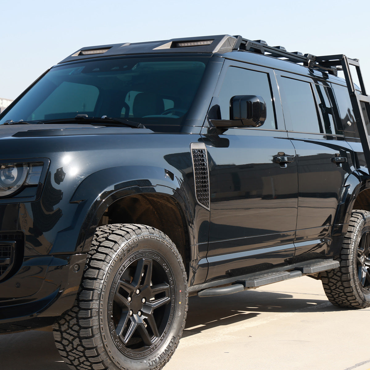 Rear angle installed roof ladder on Defender 110