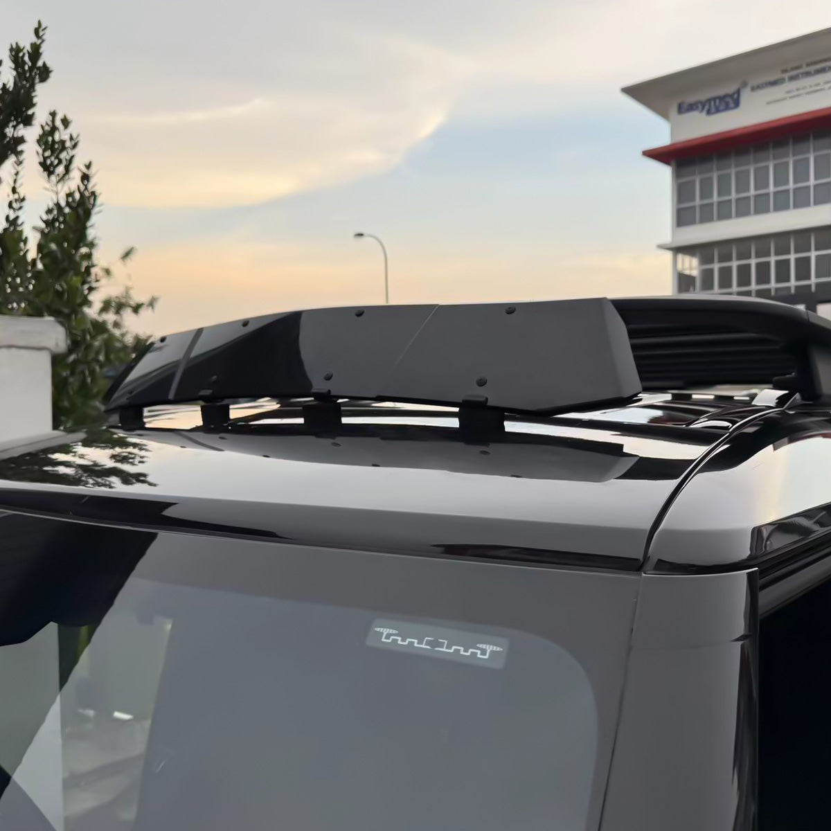 On-road driving shot of installed Defender roof wind deflector