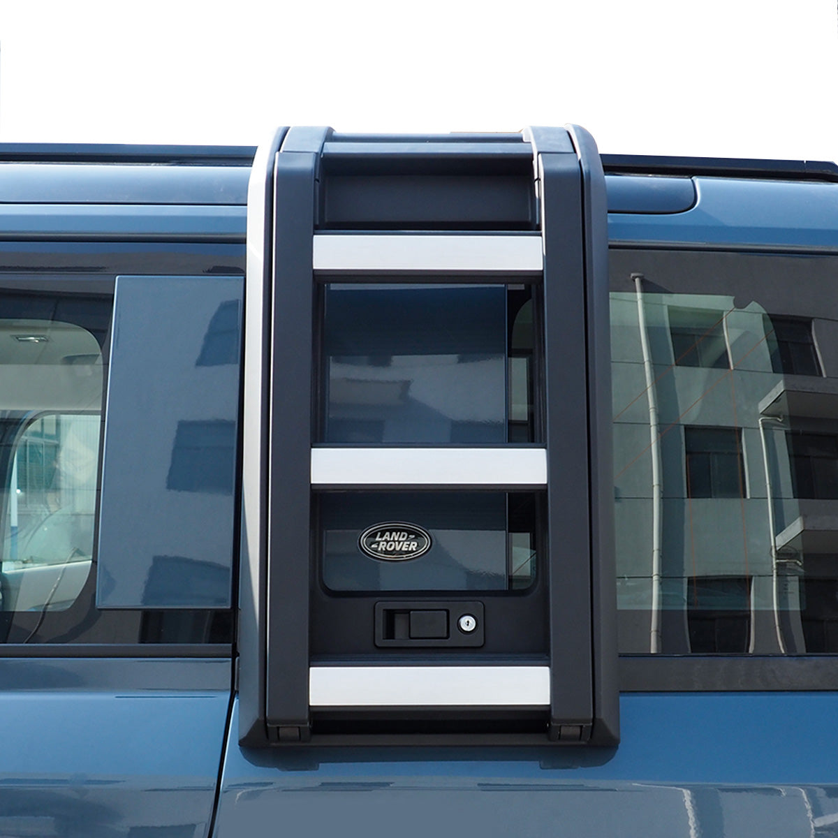 PLOMOR Side Ladder mounted on Defender navigating off-road terrain
