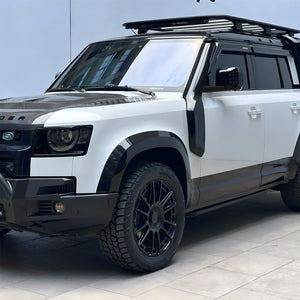 PLOMOR snorkel kit in use on rugged off-road terrain with Defender