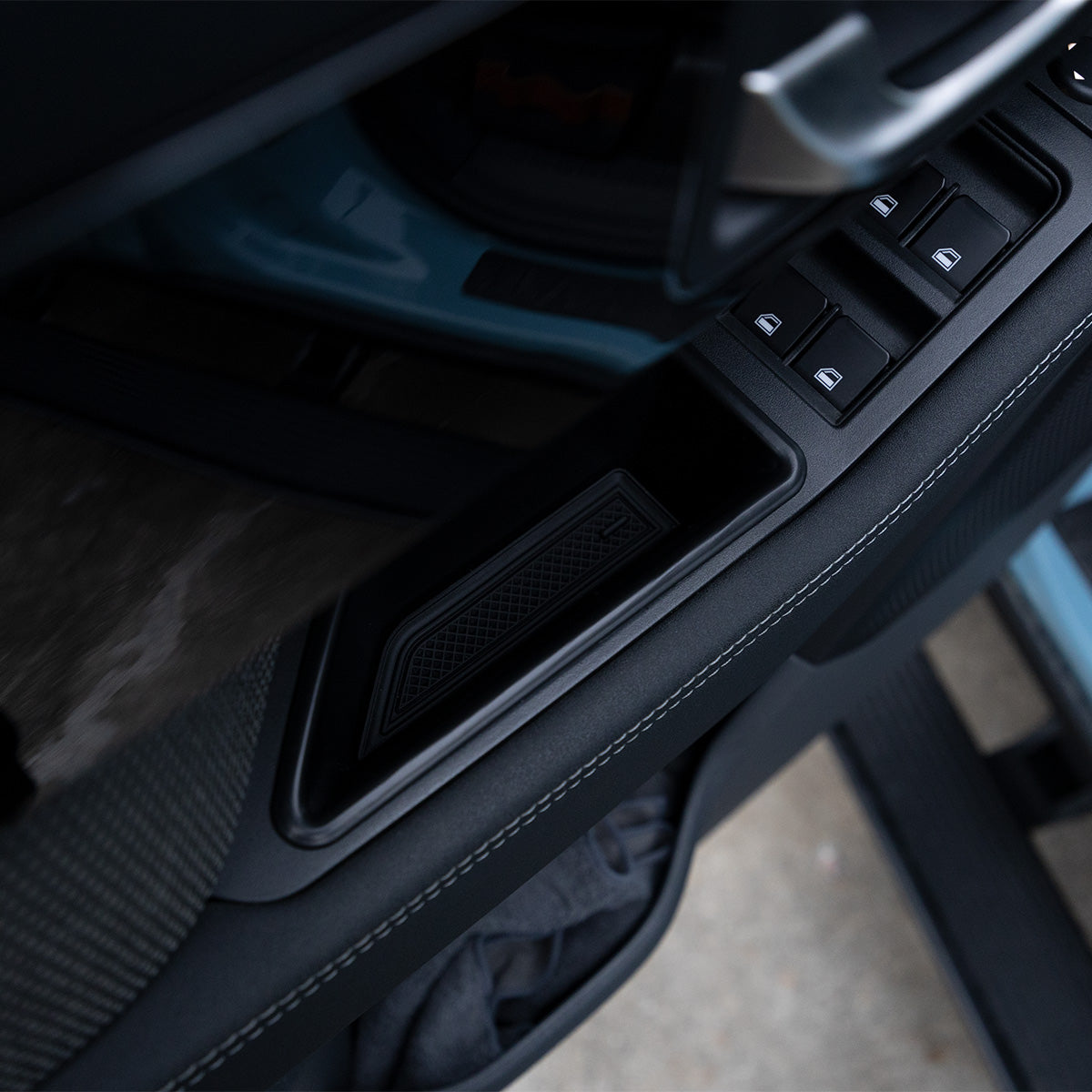 PLOMOR Door Handle Storage Box installed in the INEOS Grenadier door pull. Provides a convenient, secure spot for small items, easily inserted without tools or adhesive.