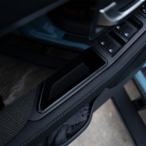 PLOMOR Door Handle Storage Box installed in the INEOS Grenadier door pull. Provides a convenient, secure spot for small items, easily inserted without tools or adhesive.