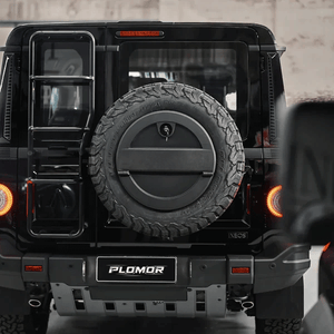 Ineos Grenadier equipped with spare wheel storage box during off road driving scenario