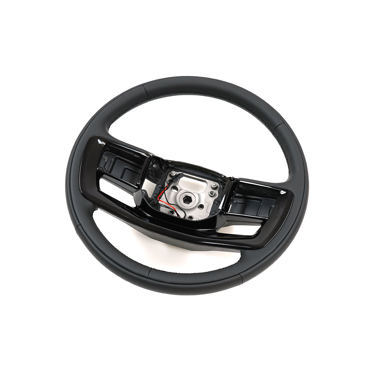 Close-up detail of PLOMOR heated steering wheel premium material finish