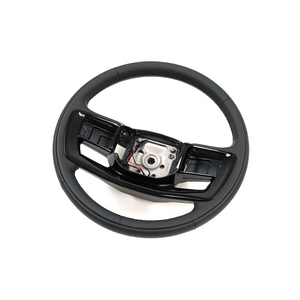 Close-up detail of PLOMOR heated steering wheel premium material finish