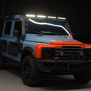 Ineos Grenadier fitted with a roof-mounted ABS light bar, shown illuminated and integrated on the vehicle’s roof for enhanced visibility and off-road use.