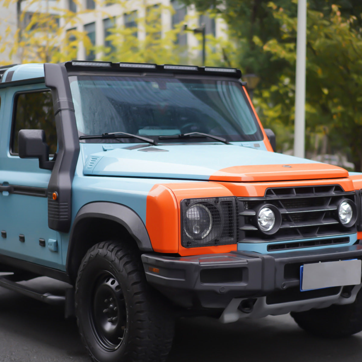 Ineos Grenadier fitted with a roof-mounted ABS light bar, shown illuminated and integrated on the vehicle’s roof for enhanced visibility and off-road use.