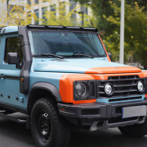 Ineos Grenadier fitted with a roof-mounted ABS light bar, shown illuminated and integrated on the vehicle’s roof for enhanced visibility and off-road use.