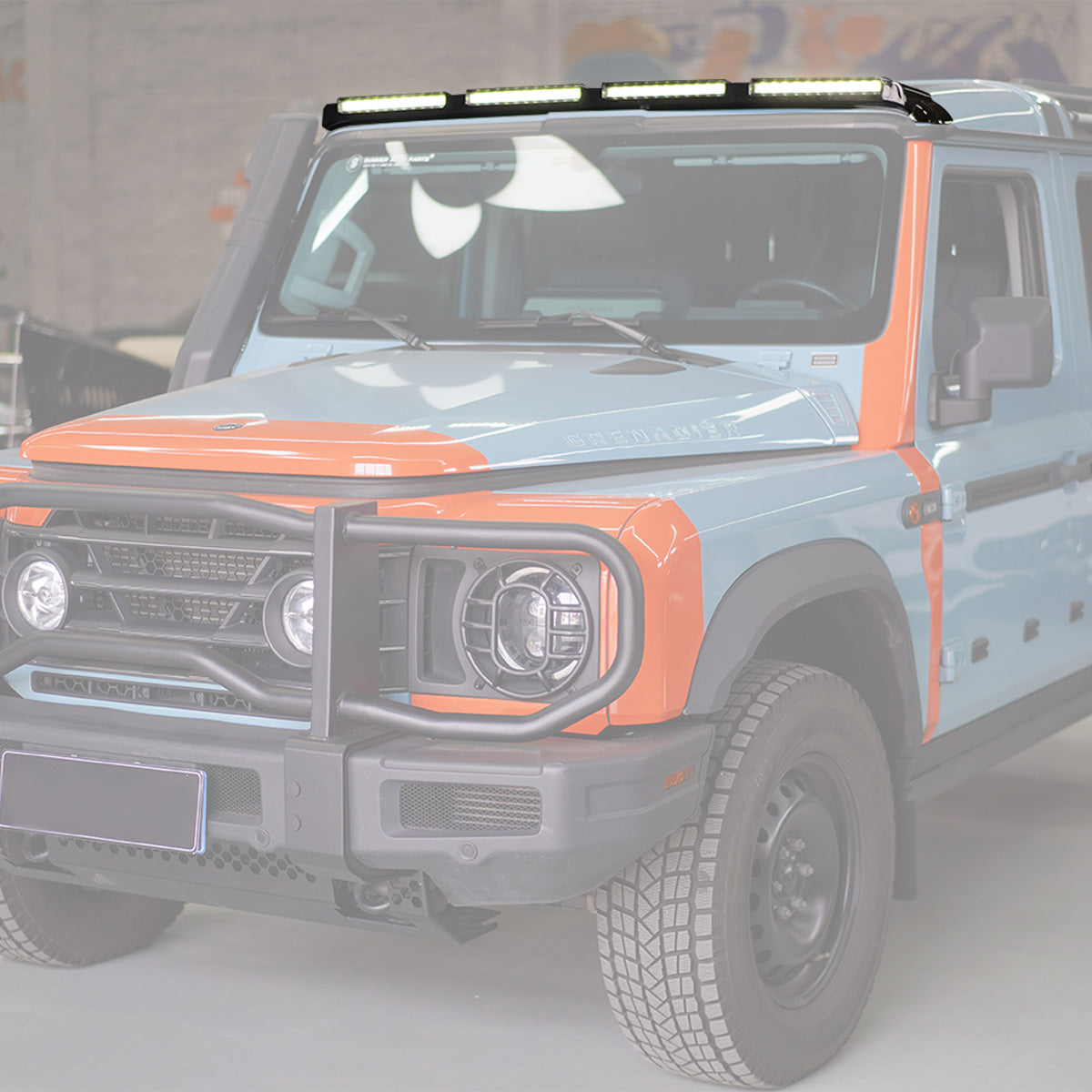 Ineos Grenadier fitted with a roof-mounted ABS light bar, shown illuminated and integrated on the vehicle’s roof for enhanced visibility and off-road use.