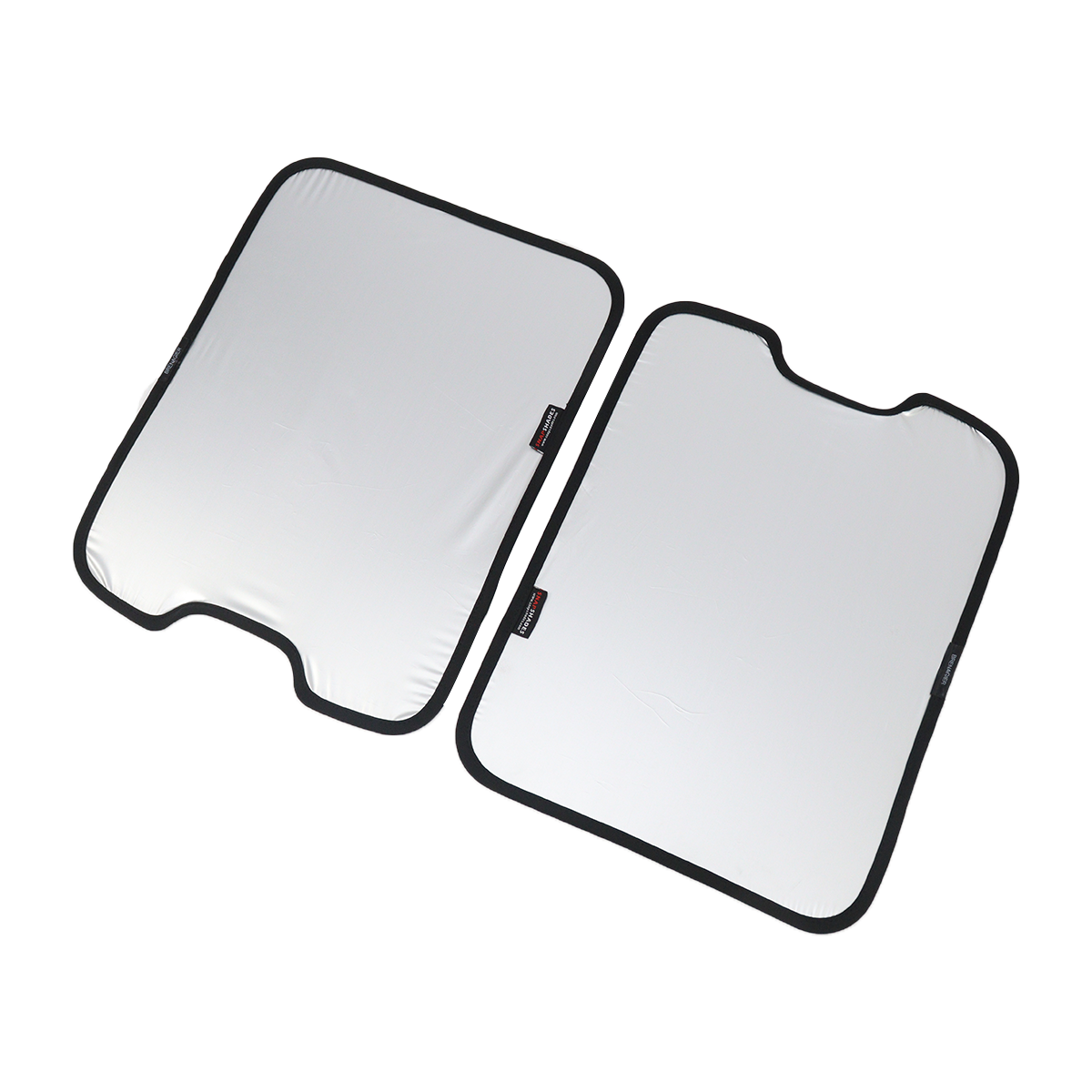 PLOMOR two-piece skylight roof sunshade for INEOS Grenadier—silver reflective side, left panel with bottom notch, right panel with top notch; top-down angled view with black edging