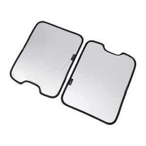 PLOMOR two-piece skylight roof sunshade for INEOS Grenadier—silver reflective side, left panel with bottom notch, right panel with top notch; top-down angled view with black edging