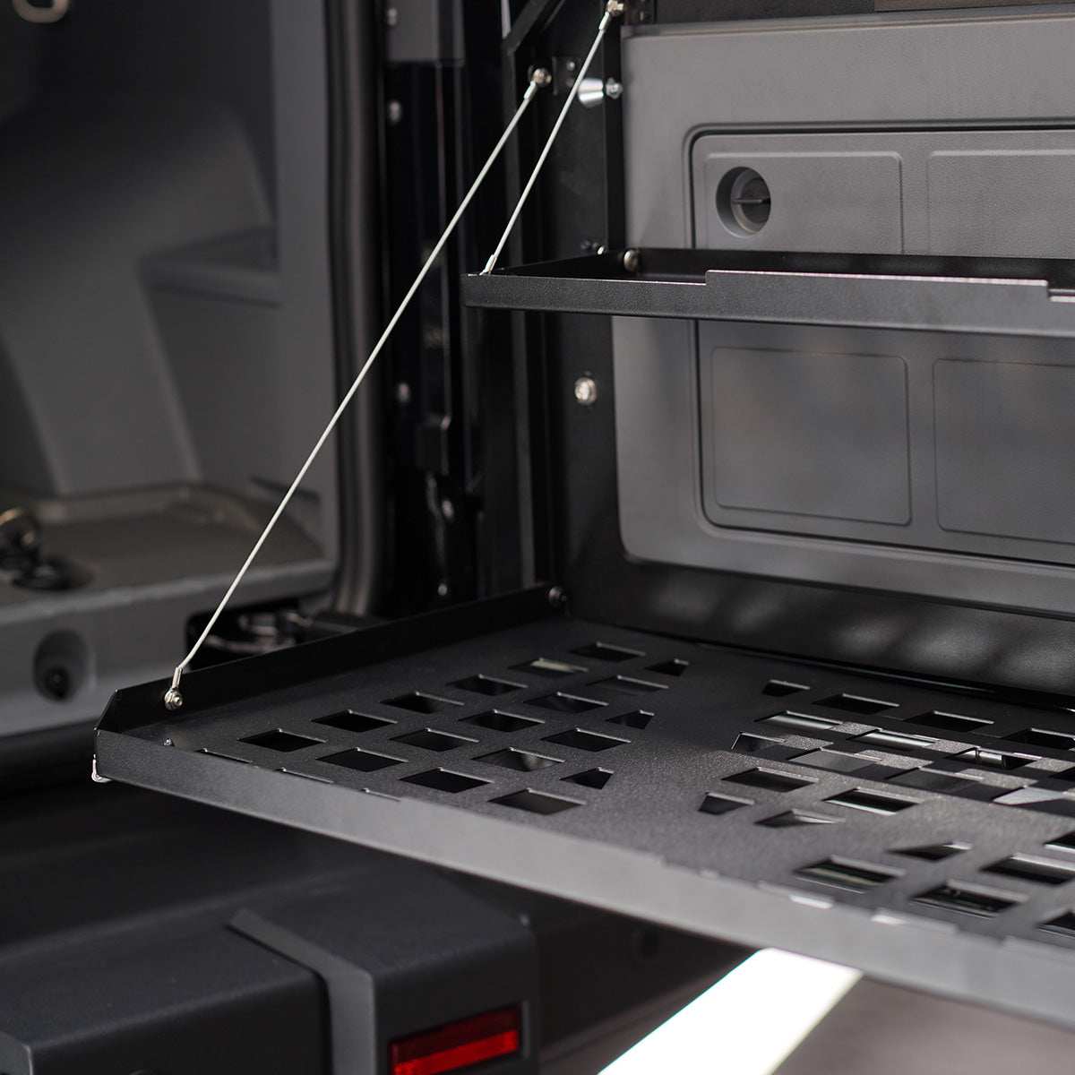 PLOMOR Heavy-Duty Rear Tailgate Folding Table for INEOS Grenadier. Powder-coated steel multi-function platform for overlanding, camping, and stable workspace.