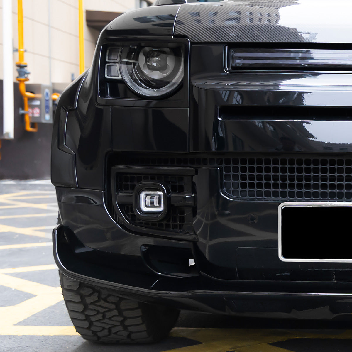 Land Rover Defender L663 front lip side profile with OEM-style integration and aerodynamic design