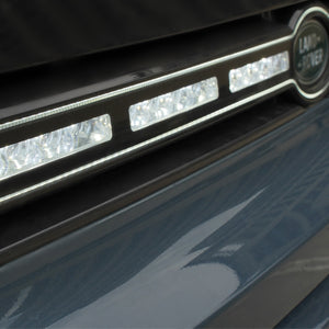 Side view of PLOMOR LED grille installed on Defender 130