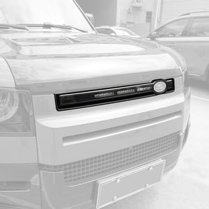 Angled view of PLOMOR LED grille installed on Defender 90