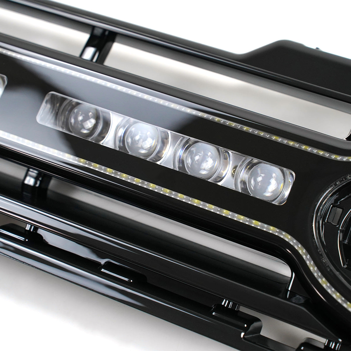 Detailed close-up of PLOMOR LED grille for Defender 90/110/130