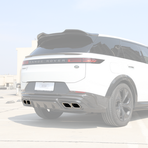 Rear three-quarter view showing quad chrome exhaust tailpipe tips installed with a carbon-fiber rear diffuser on a Range Rover.