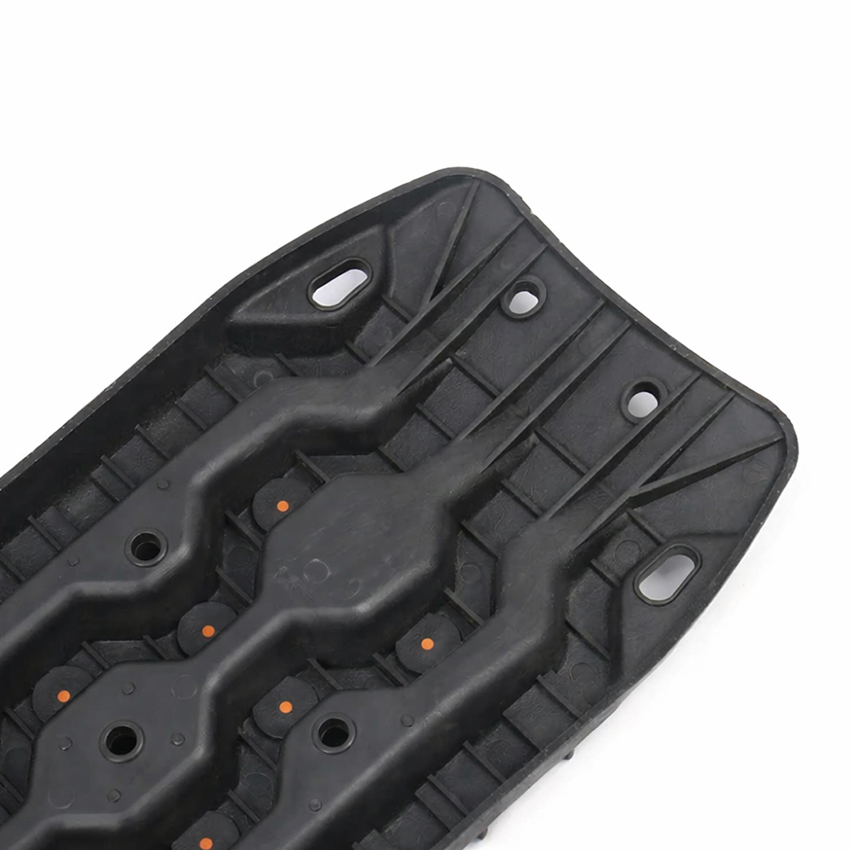 Black off-road recovery traction board with orange cleats, shown in angled three-quarter view on a white background.