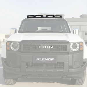 PLOMOR four-lamp roof light cover in gloss black on Toyota LC250, bright front-on outdoor view