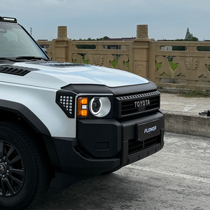 PLOMOR hood deflector on Toyota LC250, bright front-on outdoor installed view