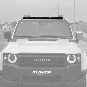 PLOMOR ABS triple roof lighting cover in gloss black on Toyota LC250, dark front-on installed shot highlighting silhouette