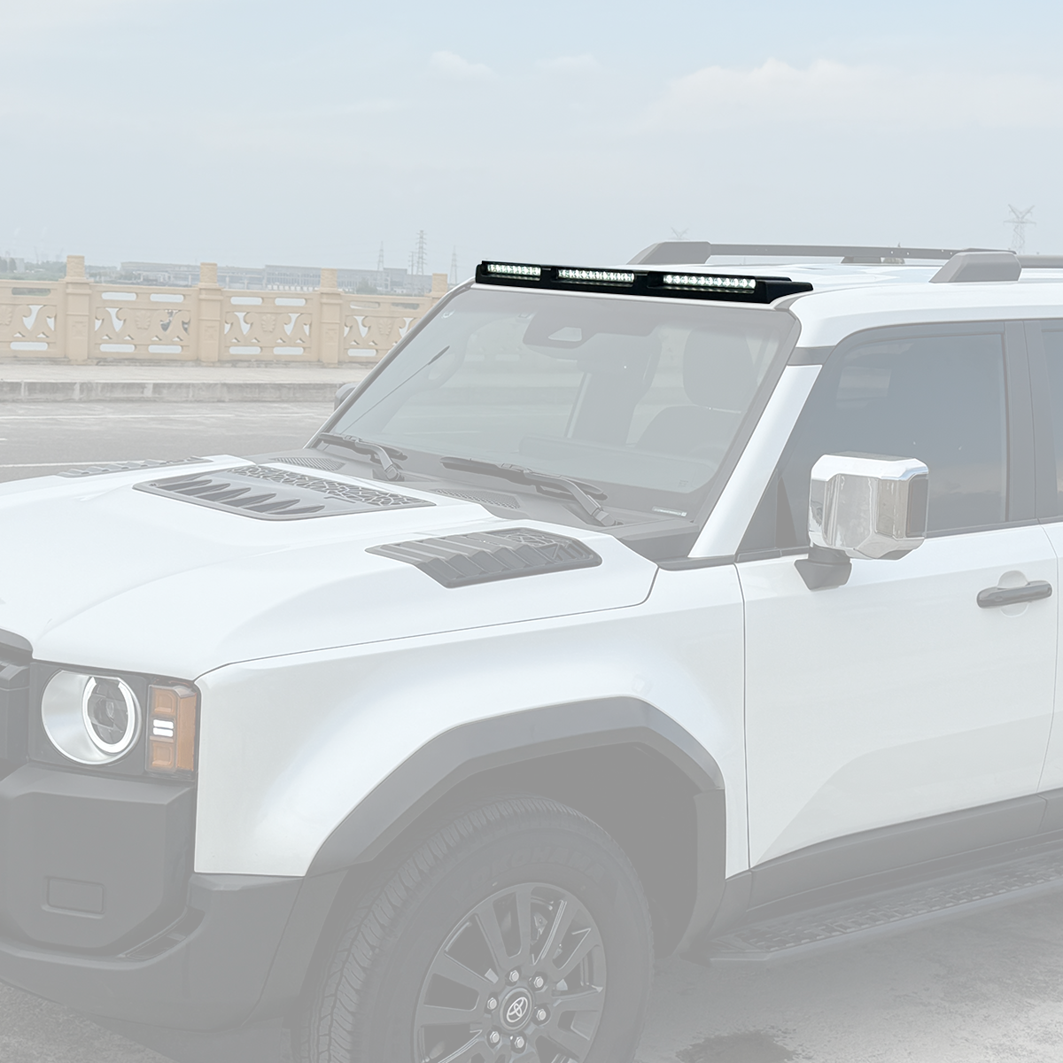 PLOMOR gloss black ABS triple roof lighting cover on Toyota LC250, on-vehicle side profile in outdoor scene