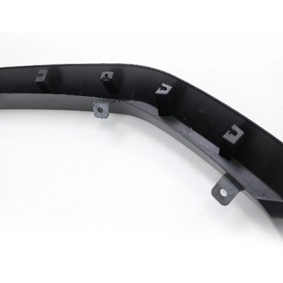 Single front section of PLOMOR LC250 wide body fender flare in matte black ABS, close-up