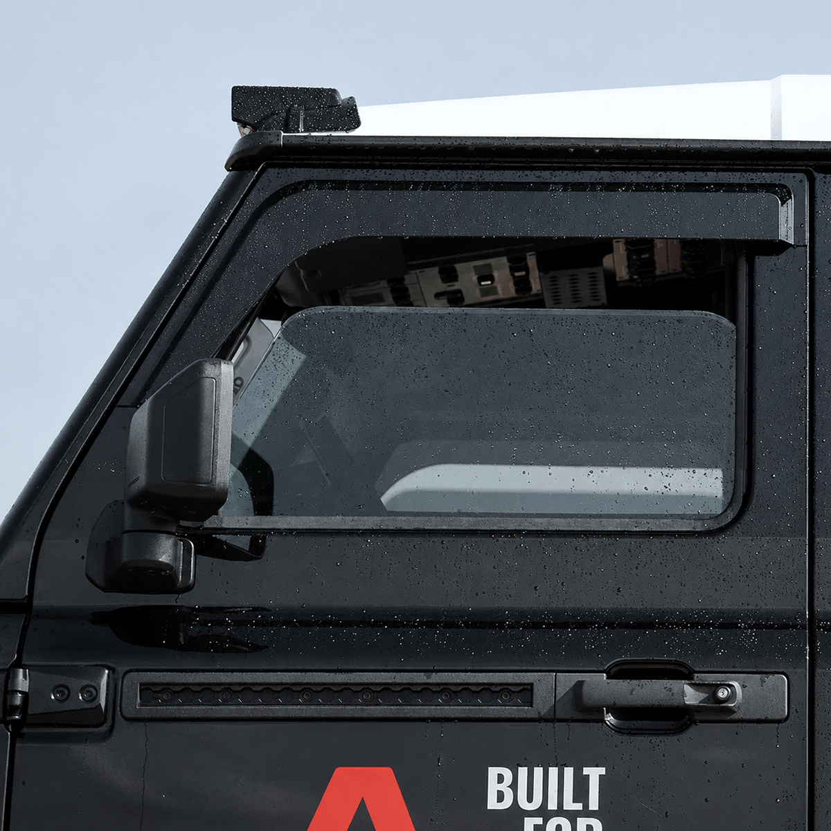 PLOMOR window deflectors installed on INEOS Grenadier 2023–2025 side view OEM+ fitment