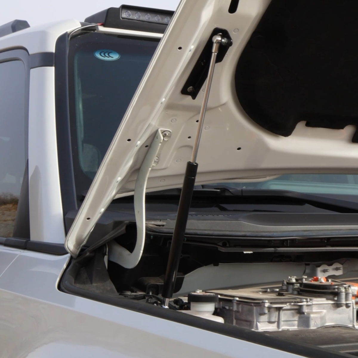 Hydraulic hood struts installed on Toyota Land Cruiser LC250, replacing the factory prop rod for automatic hood lifting