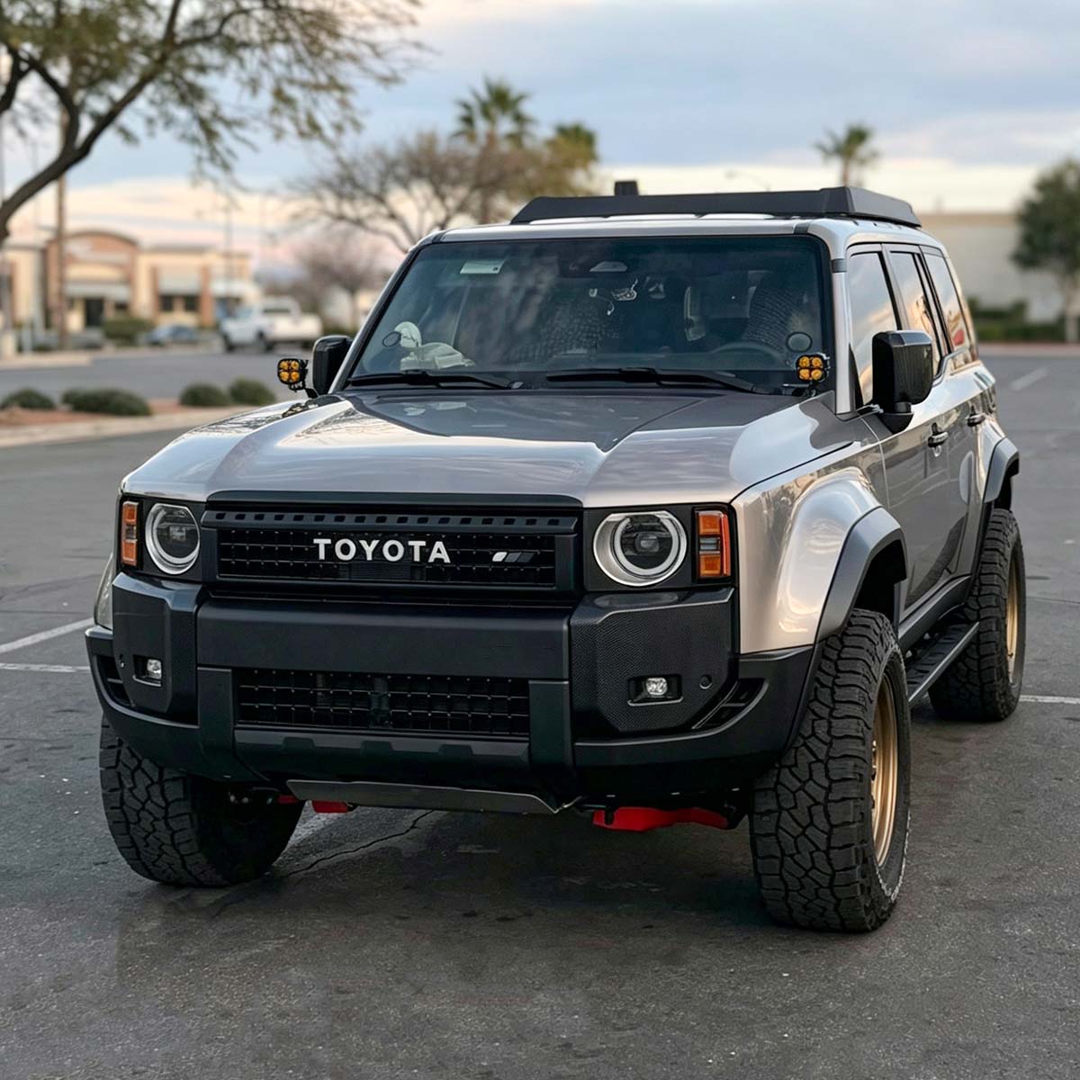 Toyota Land Cruiser LC250 with wide fender flares on off-road terrain