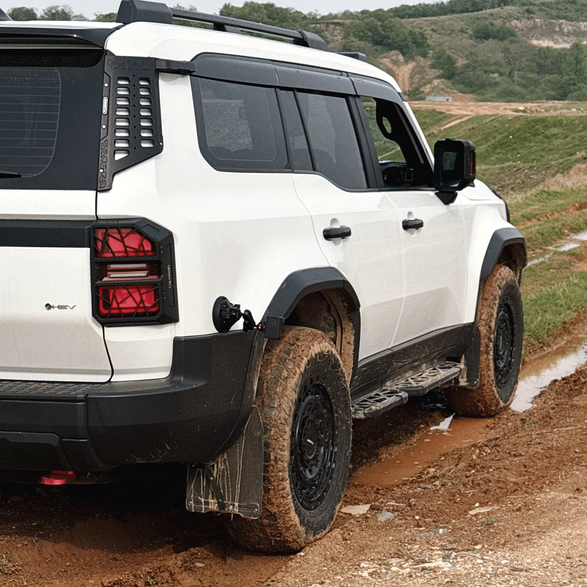 Toyota Land Cruiser LC250 fitted with PLOMOR wide body fender flares front three-quarter view