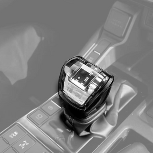Luxury crystal gear shift knob for Toyota LC250, diamond-cut exterior with surrounding LED ambient lighting.